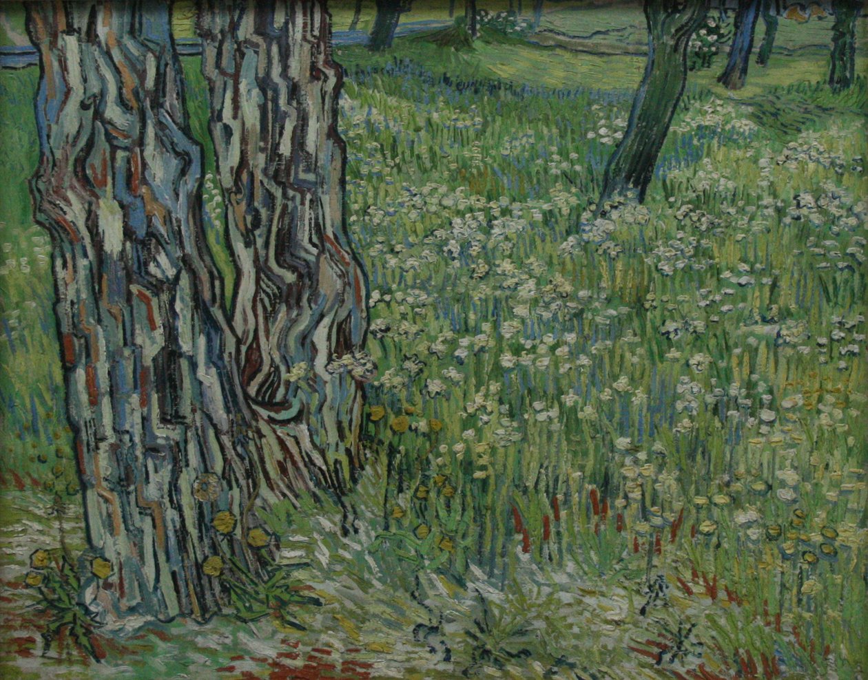 Baumstämme im Gras von Vincent van Gogh